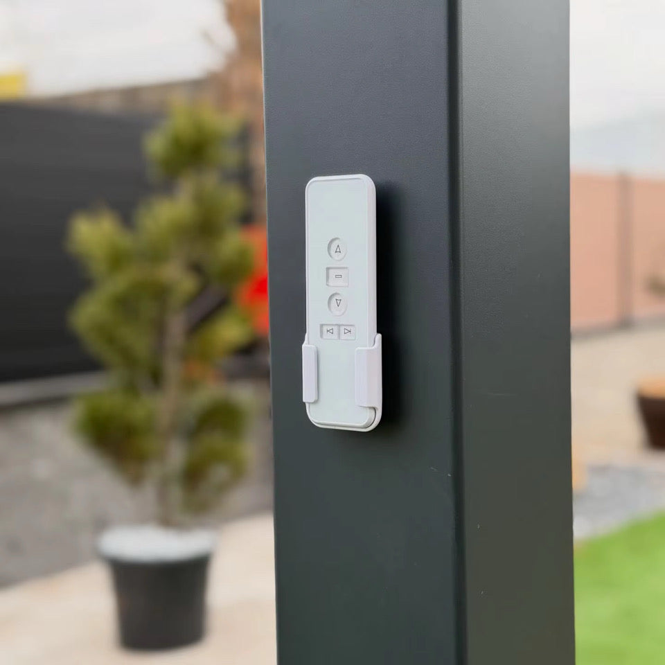 Close-up of the pergola controller mounted on a grey aluminium post; control configuration to be confirmed