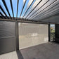 Open louvres and lighting detail in an illustrative pergola configuration with optional screen; side slat panels and furniture not included