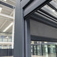 Close-up of the optional electric pergola privacy screen and grey aluminium frame