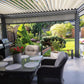 Louvre pergola over an outdoor dining area, showing an optional privacy screen; furniture excluded