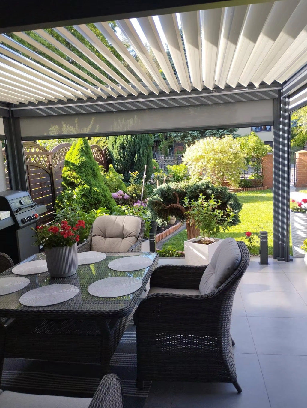 Louvre pergola over an outdoor dining area, showing an optional privacy screen; furniture excluded